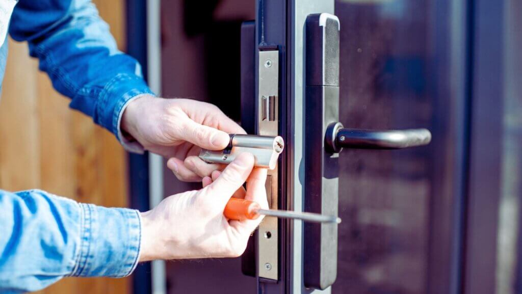 Locksmith in Tulsa OK fixing a commercial lock