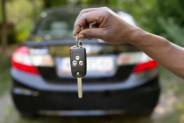 Technician programming a transponder key for vehicle