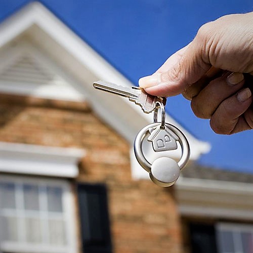 Locksmith using tools to open a house lock